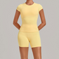 Wholesale Women's Open-Back Pleated Yoga Set Short Sleeve Crop Top & Shorts with Chest Pad