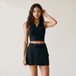 Wholesale Women's Polo Collar Fixed Cup Sports Bra & Anti-Exposure Pleated Skirt Tennis Set