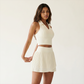 Wholesale Women's Polo Collar Fixed Cup Sports Bra & Anti-Exposure Pleated Skirt Tennis Set