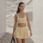 Wholesale Naked-Feel Sports Bra & Pleated Tennis Skirt Set – Quick-Dry Athletic 2-Piece with Built-In Shorts