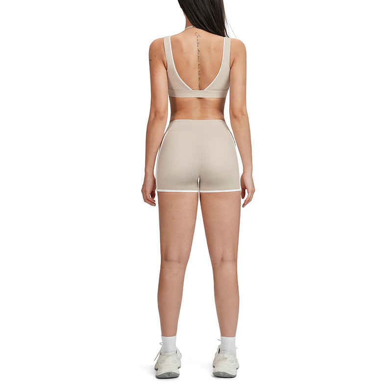Contrasting color open-back bra + high-waisted contrasting shorts 2-piece set