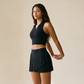 Wholesale Women's Polo Collar Fixed Cup Sports Bra & Anti-Exposure Pleated Skirt Tennis Set