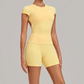 Wholesale Women's Open-Back Pleated Yoga Set Short Sleeve Crop Top & Shorts with Chest Pad