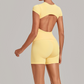 Wholesale Women's Open-Back Pleated Yoga Set Short Sleeve Crop Top & Shorts with Chest Pad