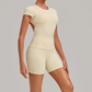 Wholesale Women's Open-Back Pleated Yoga Set Short Sleeve Crop Top & Shorts with Chest Pad